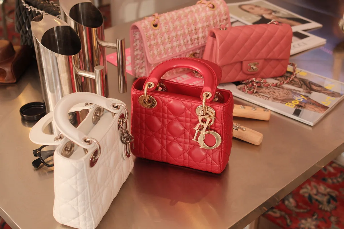 Lady Dior and Chanel bags arranged with fashion magazines