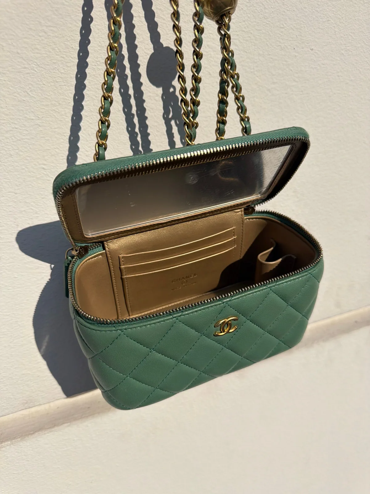 Open sage Chanel vanity pouch with card slots, mirror and gold chain